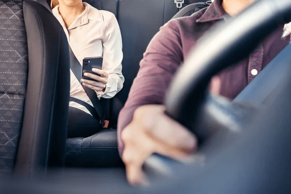 male driving a car with a woman as a passenger